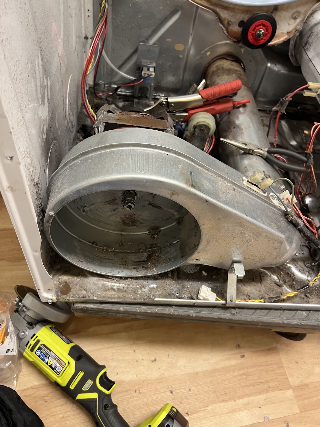 Dryer opened for service with the blower housing and internal components visible