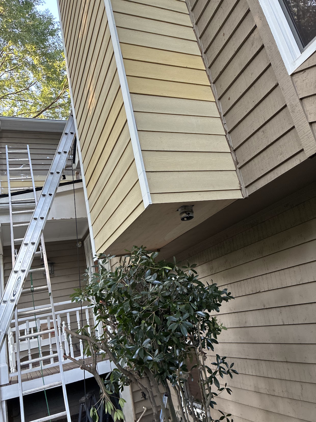 New horizontal siding and corner trim installed on the same exterior chimney enclosure
